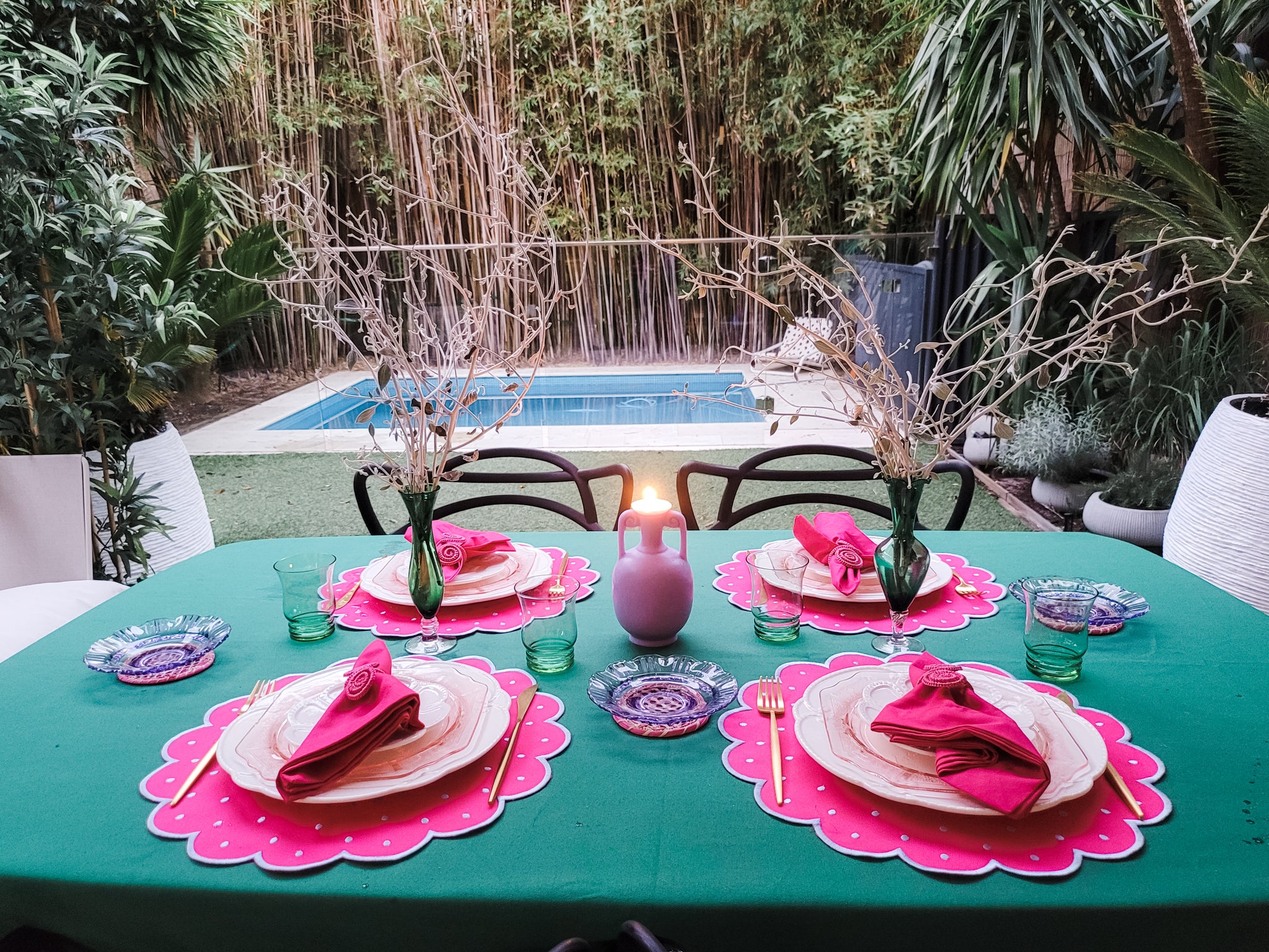 The Clara Collection - bold pink scalloped placemats on an emerald green tablecloth. Pink and green inspired nostalgia from the 70s. Setting the table pretty